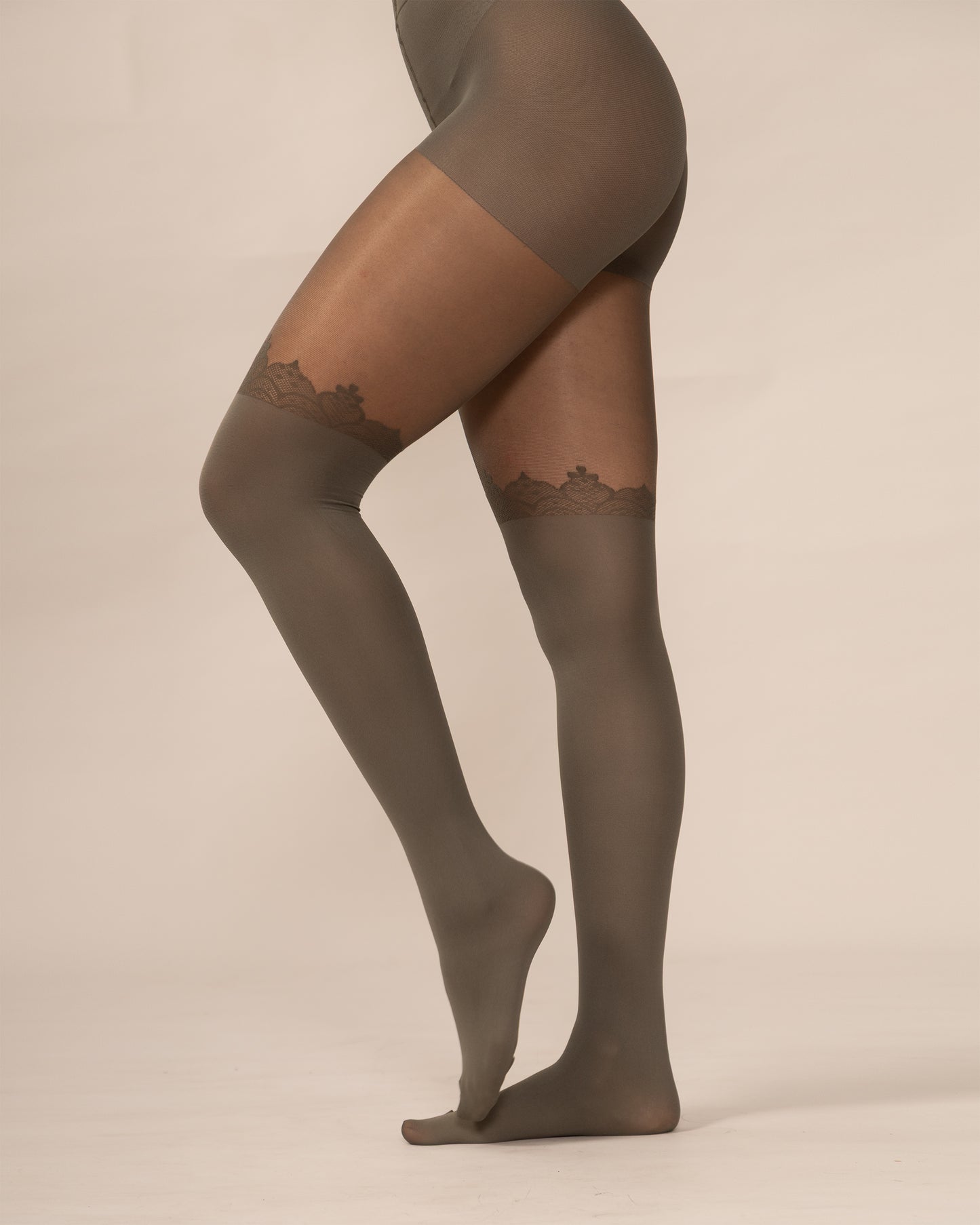 Olive tights with lace details on a beige background
